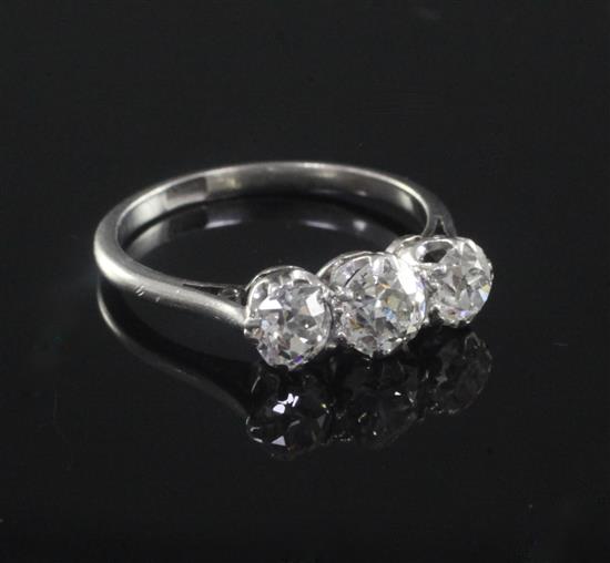 A 1930s/1940s platinum and three stone diamond ring, size M.